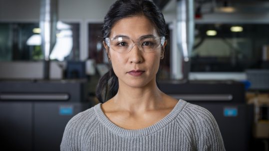 woman with protective goggles looking confidently and directly at the camera