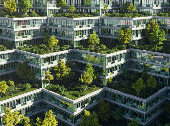A futuristic, tiered complex of buildings integrates dense greenery into its terraces, blending architecture and nature.