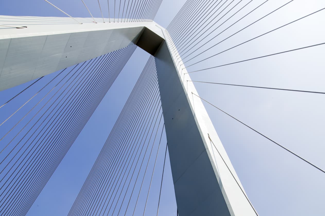 Abstract architectural detail of a suspension bridge’s towering structure and tension cables, emphasizing symmetry and engineering precision